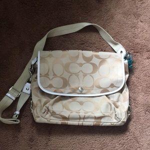 Tan Coach laptop bag with lavender interior